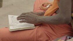 C/U sadhu reading a book, hands Stock Footage