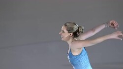 SLO MO Female figure skater finishing performance by raising hands Stock Footage