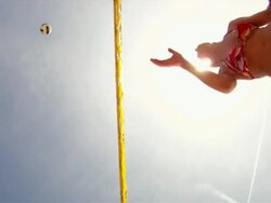POV LA WS of female beach volleyball players spiking and blocking at the net with sun. Stock Footage