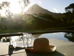 Swimming pool looking out to scenic mountain sunset Stock Footage