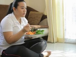 Fat woman eating salad Stock Footage