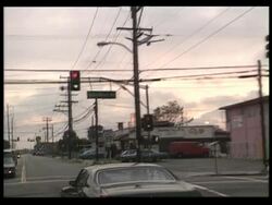 1992 MONTAGE LA WS PAN Airplane flying over city / Civilians gathering outside homes in aftermath of LA riots / Los Angeles, California, USA Stock Footage