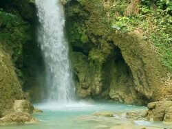 MS SLO MO Shot of bottom of waterfall with brown rocks / Kuang Si, Luang Prabang, Laos Stock Footage
