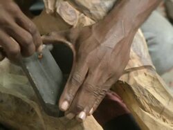 CU Sculptor sharpening tool on stone / Havana, Cuba Stock Footage
