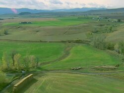 Low altitude aerial over rollings hills and fields in autumn near Bozeman, MT Stock Footage