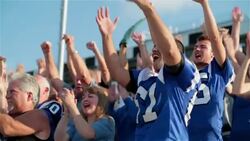 Anxious stadium crowd jumps up and cheers at football game Stock Footage