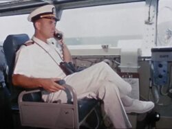 1962 Intrepid captain giving orders for recovery of Mercury 7 capsule / looking through binoculars Stock Footage