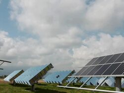 T/L of clouds blowing overhead solar reflectors Stock Footage