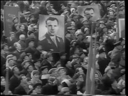 B/W 1961 high angle zoom in crowd holding posters with photographs of Yuri Gagarin (first man in space) / Moscow Stock Footage