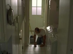 WS, Man cleaning tile floor in laundry room, Hollywood, California, USA Stock Footage