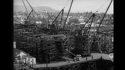 Ship builders building hull of cargo ship in shipyard in Vancouver, British Columbia, Canada News Clip