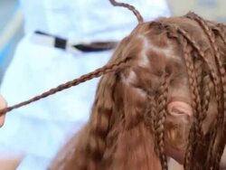 process of unbraid braids on red-haired teenage girl Stock Footage