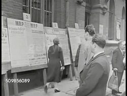 1946: FRANCE REPUBLICAN PROPAGANDA: EXT WS French pedestrians reading Mouvement Rpublicain Populaire (MRP) signs. CU Man reading, 'votez.' CU Poster 'Votre Securite.' MS Women talking over socialist poster. (Behind) Men reading MRP poster. Instructional Video