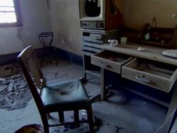 Scenic shots inside a destroyed apartment on Hashima Island in Japan showing old furniture and appliances. Stock Footage