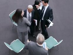  DIRECTLY ABOVE Business associates jockeying for chairs, with one man leaving in frustration / Seattle, Washington, United States Stock Footage
