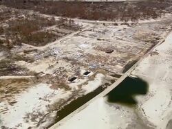 Aerial over destroyed homes and beach in coastal area / Pass Christian or Long Beach, Mississippi Stock Footage