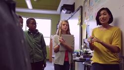 Teacher leading discussion with elementary students in classroom Stock Footage