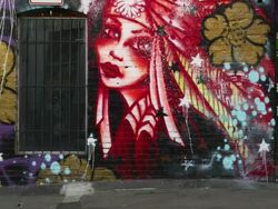 WS Man with mobile phone walking along wall covered with graffiti, Salt Lake City, Utah, USA Stock Footage