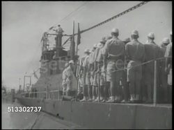 1942: JAPANESE NAVY: VS Imperial Japanese Navy crew, sailors, standing in formation on deck of submarine, listening to officer, soldiers listening, submarine moving out on waters w/ men waving from deck & on dock. World War II, WWII, Pacific Front Instructional Video