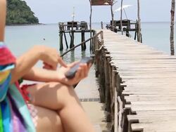 close-up young woman using smart phone on the beach Stock Footage