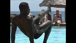 Tourists by pool and doing water aerobics News Clip