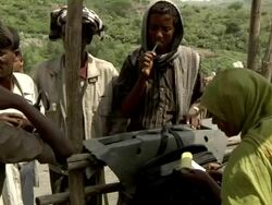 Ethiopian woman writes receipt for camel deal Stock Footage