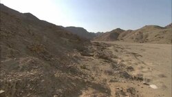 A desert road winds past ruins in Sikait, Egypt. Stock Footage