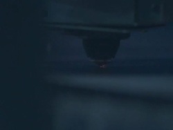 Slow motion close up of laser cutter as it punches holes in a sheet of metal. Stock Footage