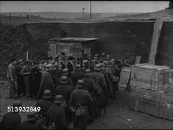 1942: NAZI GERMANY DEFENSES: VS Nazi German soldiers marching near fortifications, soldiers entering border defense wall, soldiers pushing artillery cannon into camouflaged bunker. World War II, WWII, war preparation, war effort, invasion Instructional Video
