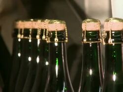 CU Champagne bottles on production line / Wiltingen, Saar-Valley, Rhineland-Palatinate, Germany Stock Footage