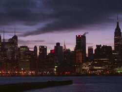 Shot of the Midtown Manhattan Skyline at night from across the Hudson River. The Empire State Building, Chrysler Building, and New York Times Building  are all in the shot Stock Footage