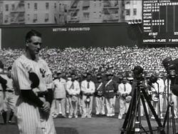 B/W 1939 Lou Gehrig standing solemnly in center of crowded stadium / farewell speech Stock Footage