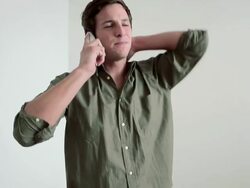 Young man standing on flooded floor on phone Stock Footage