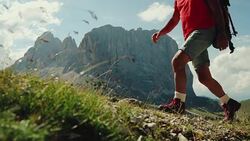 Slow-motion senior man trail hiking on high mountain Stock Footage