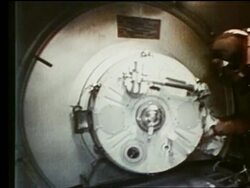Astronauts opening hatch between Apollo 18 + Soyuz 19 Stock Footage
