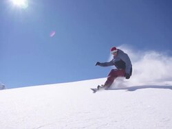 Snowboarder does powder turn Stock Footage