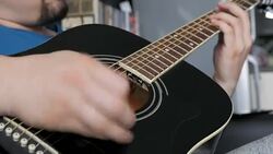 Man playing a black acoustic guitar Stock Footage