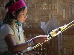 MS Shot of Young woman wearing neck rings weaving  / Inle Lake, Shan State, Myanmar   Stock Footage