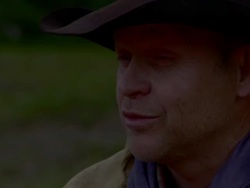 Cowboys sits at a fire Stock Footage