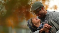 New York couple in love laugh as they hold each other in autumn park (dolly-shot) Stock Footage