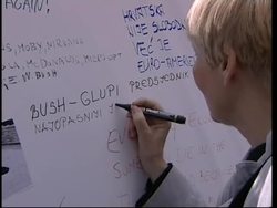 Anti-Bush demonstration; crowd gather to see Bush Instructional Video