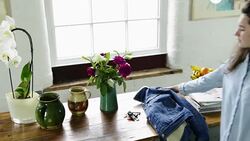 Woman picking up jacket and keys Stock Footage