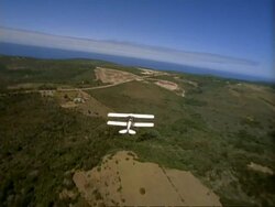 WA Aerial tracking small plane over countryside, South Africa Stock Footage