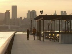 Two runners jog down a pier in Hoboken early morning. Stock Footage