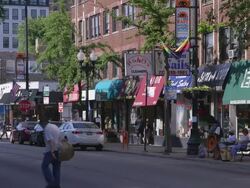 WS Street lined with shops day Stock Footage