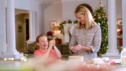 Mother and daughter roll cookie dough into balls, drop and pound on kitchen counter-top (dolly-shot) Stock Footage