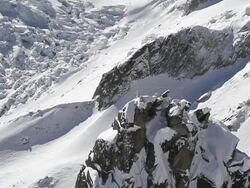 WS TS Aerial View of silver statue on summit of peak overlooking a huge beautiful glacier, mer de glasse chamonix and showing climent change, ice melting and global warming / chamonix, Haut savoir, france  Stock Footage
