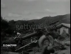 1950: U.S. TANKS AID SOUTH KOREA: VS US Tanks driving through village road, dirt roads. VS Soldiers manning artillery stations, firing. VS Tanks firing cannons. VS Soldiers loading shells into artillery, firing. MS Village on fire. Korean War Instructional Video