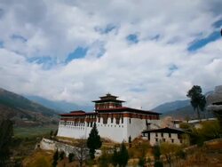 T/L, WS, clouds passing over the Paro Dzong / Paro, Bhutan Stock Footage
