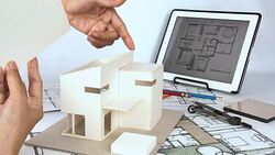 Architect working with house model & blueprints Stock Footage